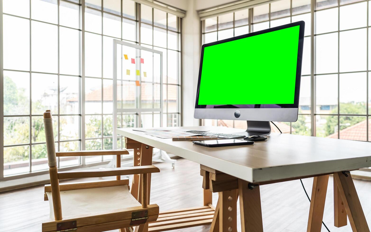 Modern office interior, Luxury office, Blank computer desktop with keyboard, paperwork and other accessories on wood table in sunny room, mock up photo