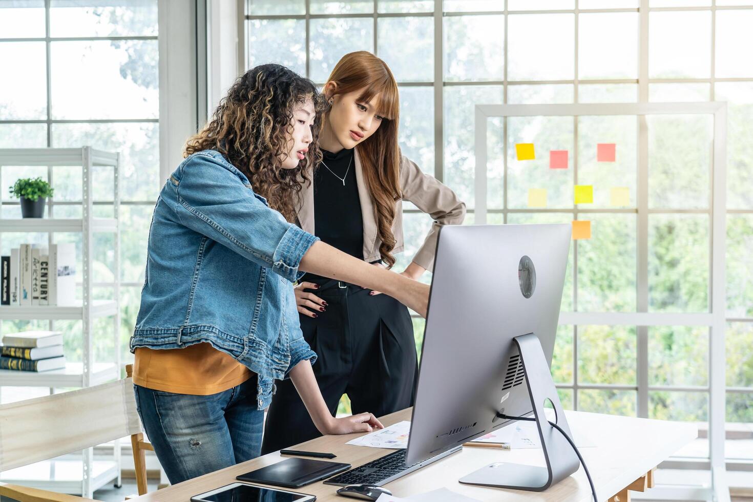 Collaboration of graphic design business people with computer in an office company, Two corporate women in creative marketing team working on project management photo