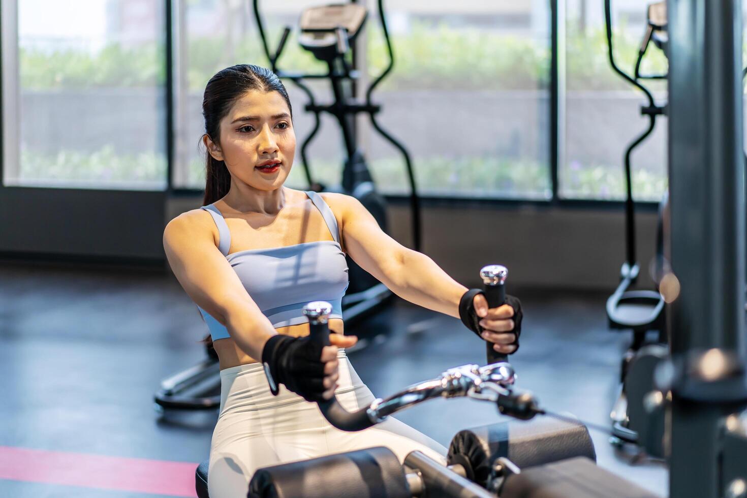Front view of Asian women doing exercises in fitness, exercises to strengthen muscles and strength, lose body fat burning, pre-workout warm-up, Concept of health care women. photo