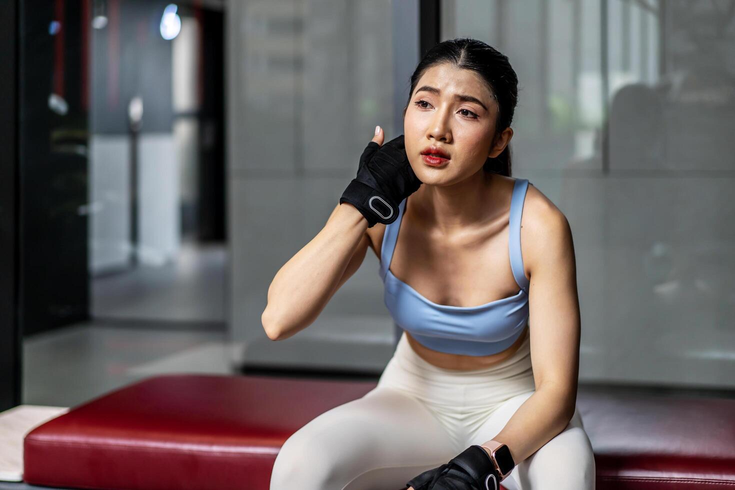 Portrait young asian woman in gym after workout, tired have sweaty and shortness of breath after physical training or exercise to burn energy, build muscle strength on training class in fitness. photo