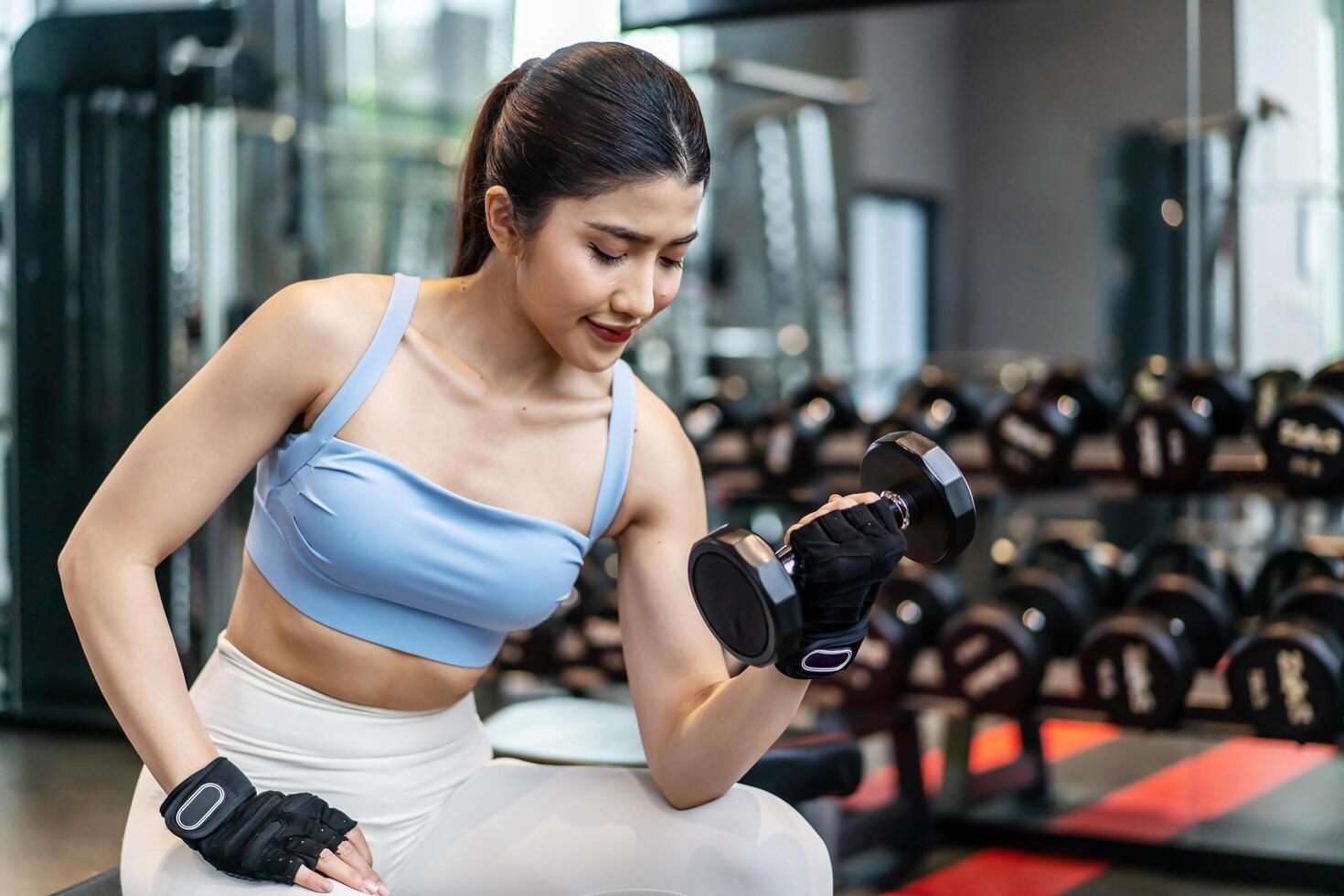 Weights training, Young asian woman lifting weights with equipment in the background, Sportswear girl workout with strong beautiful fit body shape, Asia lifestyle with copy space photo