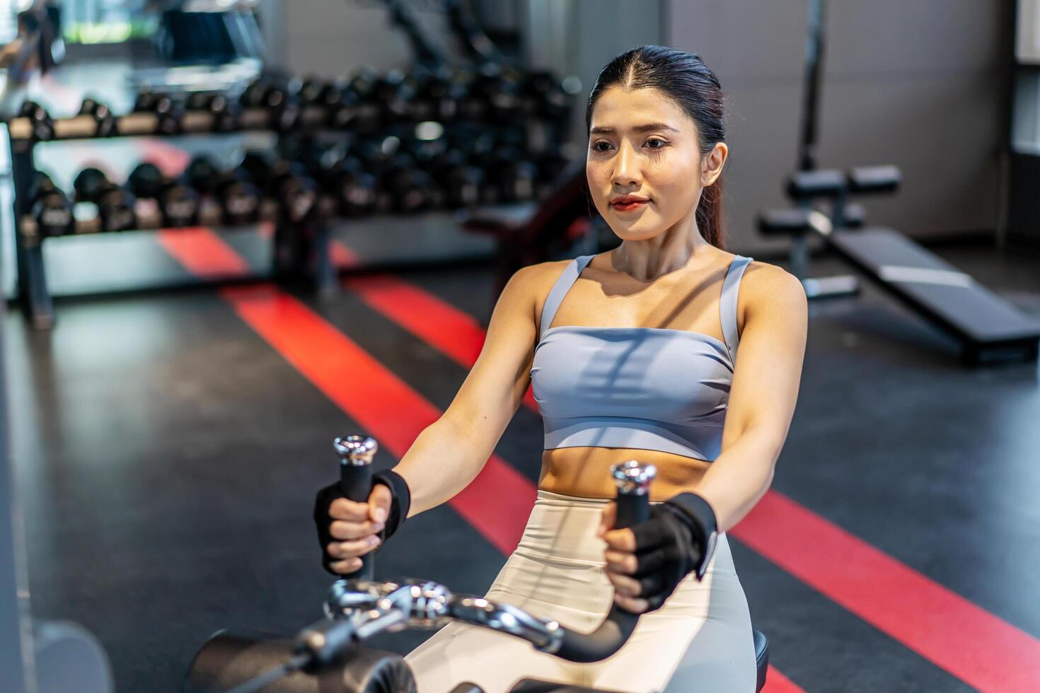 Front view of Asian women doing exercises in fitness, exercises to strengthen muscles and strength, lose body fat burning, pre-workout warm-up, Concept of health care women. photo