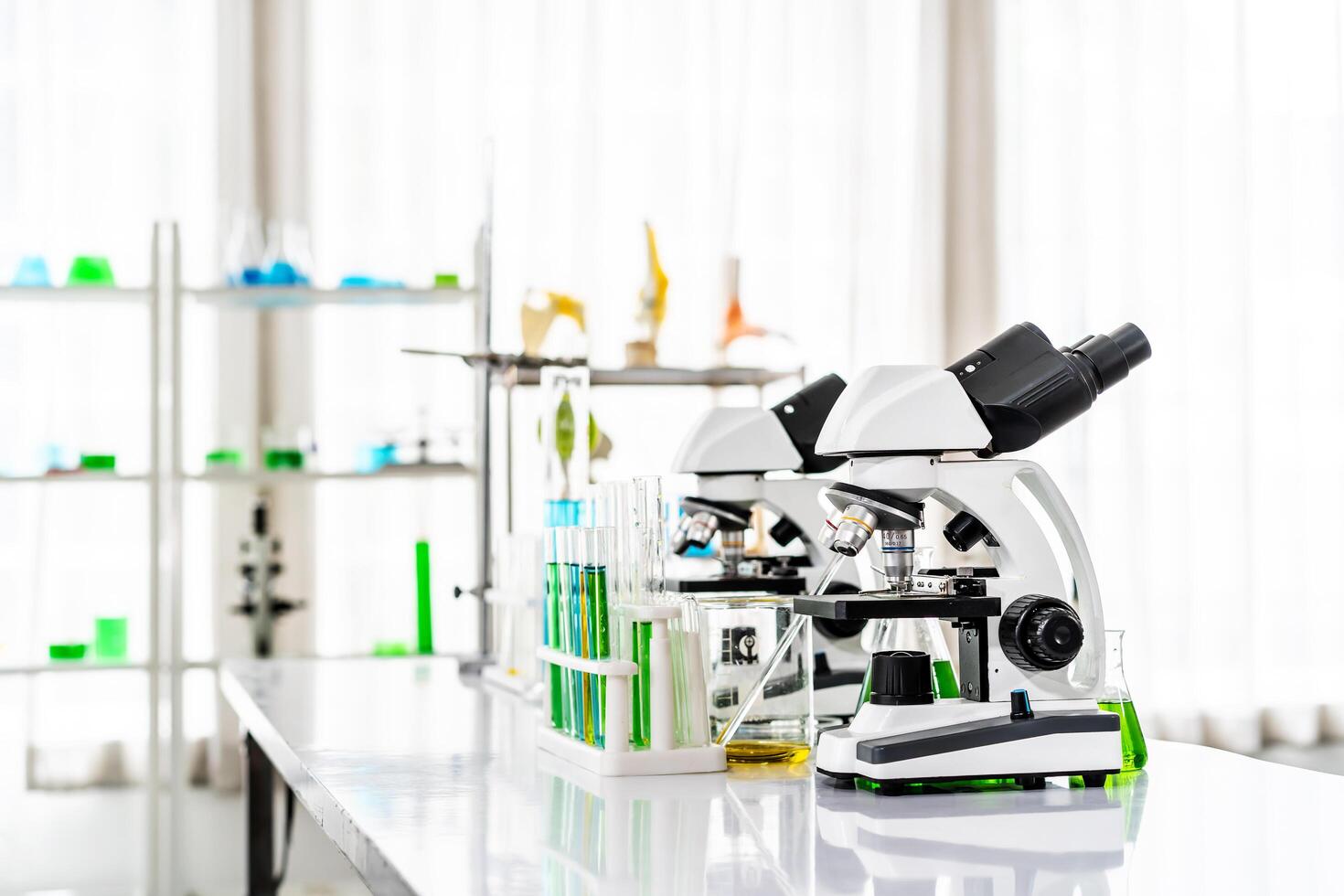 Colorful rows of laboratory or classroom test tubes and microscope with metal lens, Science and education. Scientific experiment, Researcher, Concept of medical or science laboratory, photo