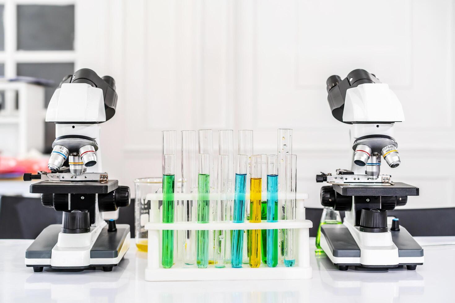Colorful rows of laboratory or classroom test tubes and microscope with metal lens, Science and education. Scientific experiment, Researcher, Concept of medical or science laboratory, photo