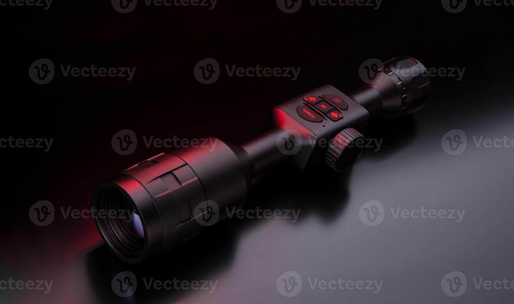 Modern sniper scope on a dark back. Optical device for aiming and shooting at long distances. photo