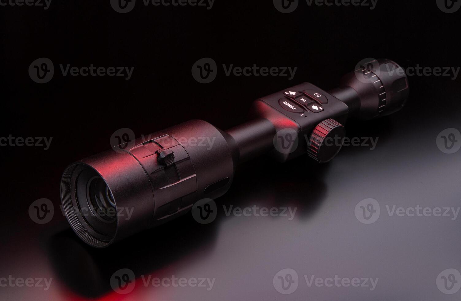 Modern sniper scope on a dark back. Optical device for aiming and shooting at long distances. photo