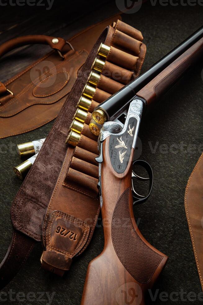 Classic trigger double-barreled hunting rifle on a green background. Smooth-bore hunting rifle open for reloading. Concept postcards for hunters. photo
