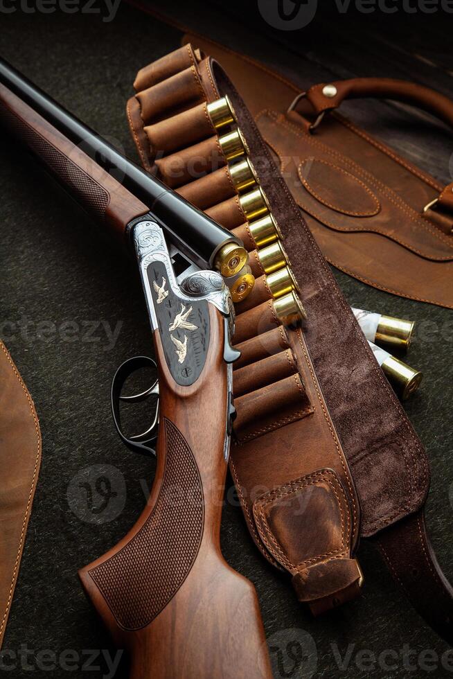 Classic trigger double-barreled hunting rifle on a green background. Smooth-bore hunting rifle open for reloading. Concept postcards for hunters. photo
