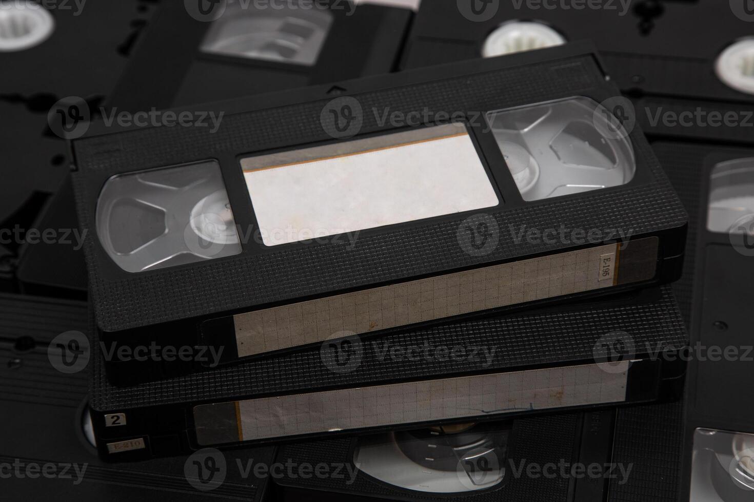 Videotape with blank tags. Pile of VHS cassettes. Vintage media. Isolate on a white back photo