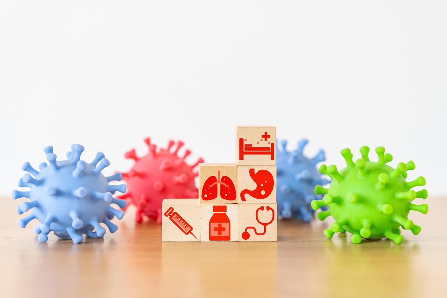 Medical icon on wooden cube block stack on white background and facked colors plastic virus shape, vaccination, laboratory, virus prevention, health, medical technology and insurance concept photo