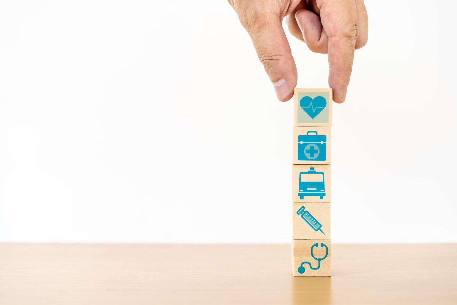 Hand arranging wood block stacking with the medical icon for healthcare and Health insurance management concept photo