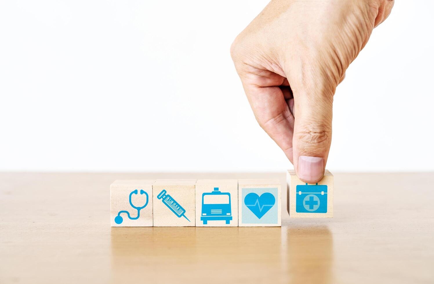 Hand arranging wood block stacking with the medical icon for healthcare and Health insurance management concept photo