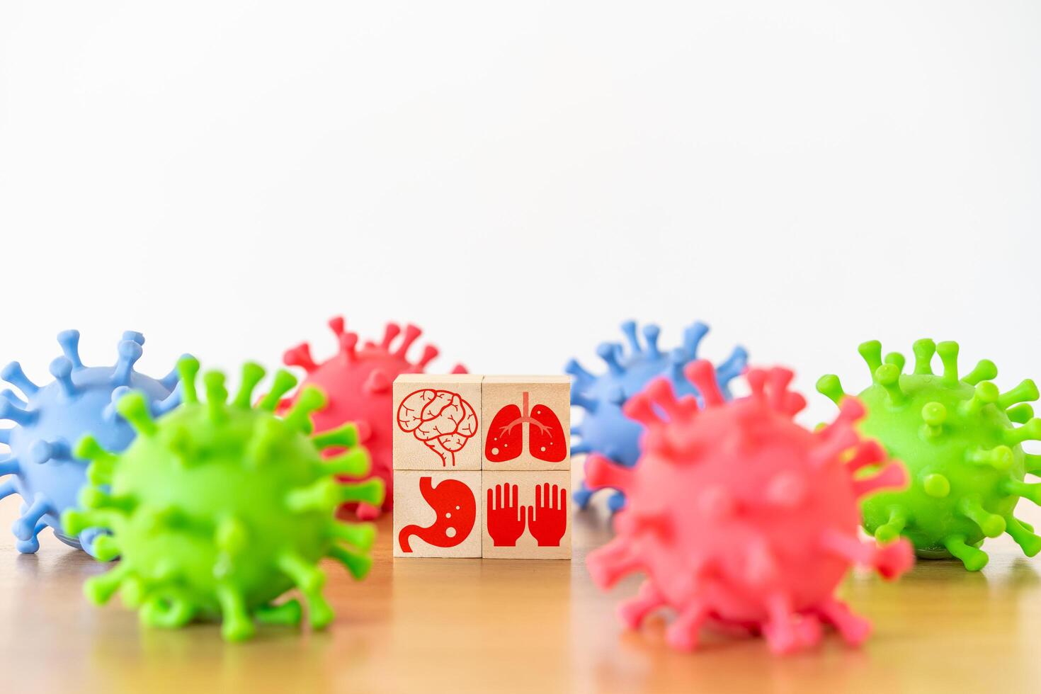 Healthcare. body parts human icon on wooden cube block stack on white background and facked colors plastic virus shape, vaccination, laboratory, virus prevention, health, medical technology photo