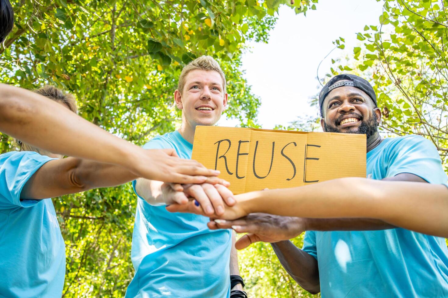 Group of volunteers stand to put your hands up and raise your hands together for help to save nature collecting garbage, Natural environment, pollution concept, Cleaning of nature from waste photo