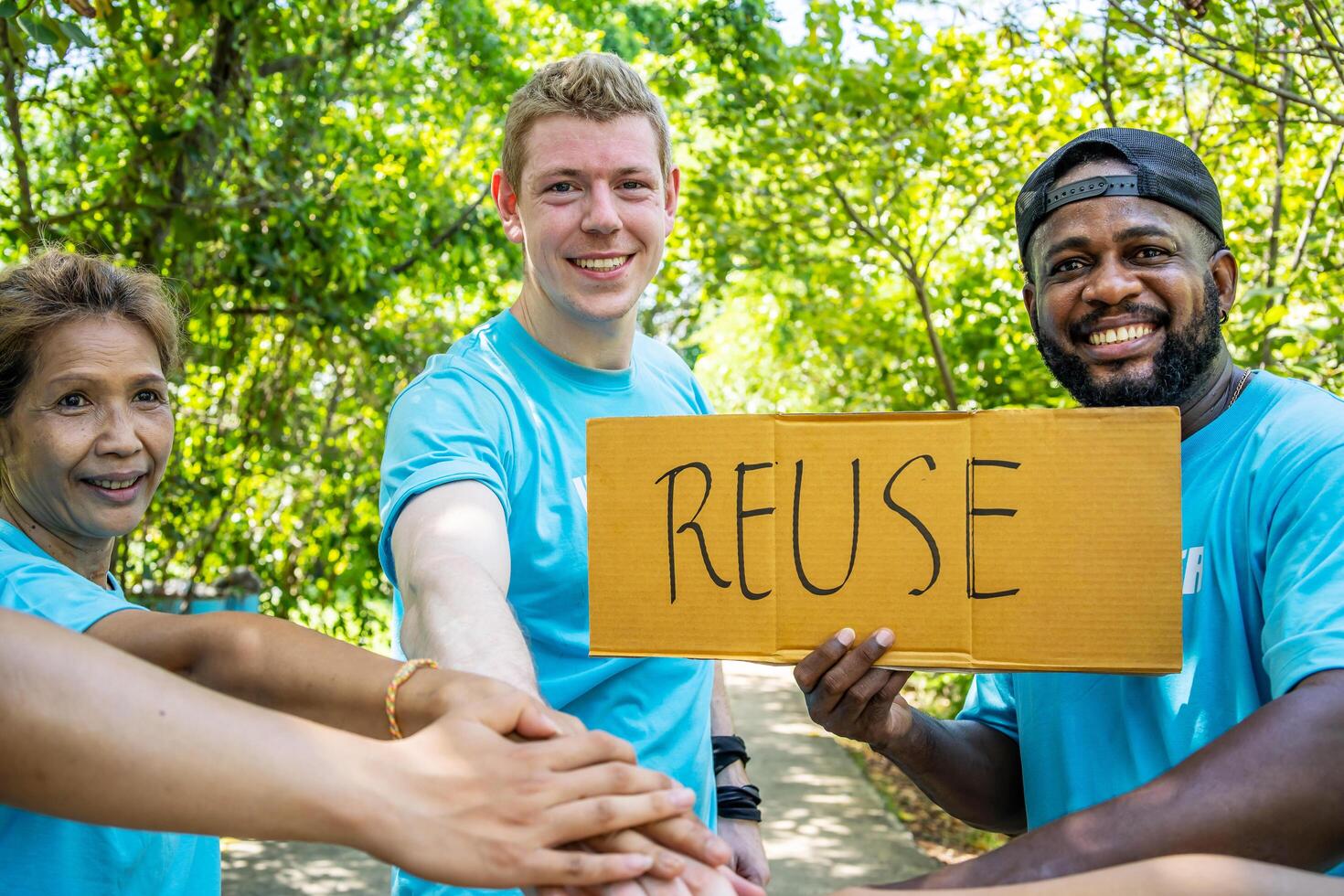 Group of volunteers stand to put your hands up and raise your hands together for help to save nature collecting garbage, Natural environment, pollution concept, Cleaning of nature from waste photo