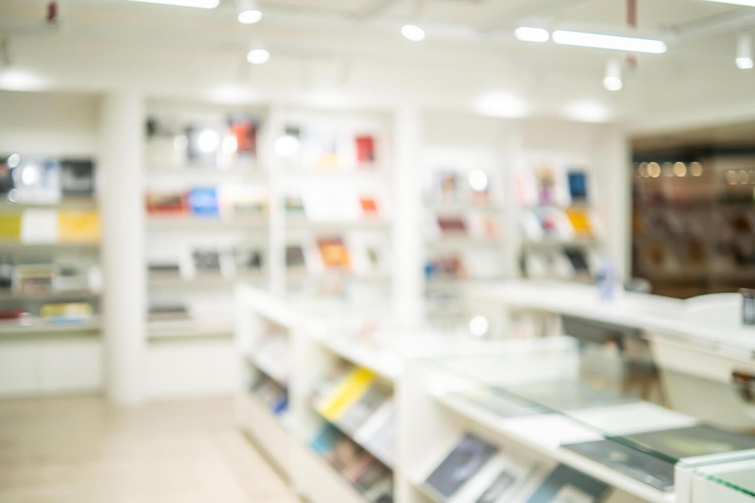 Abstract blurred of the interior of the public library with wooden tables, chairs and books in bookshelves. use for background or backdrop in book shop business or education resources concepts photo