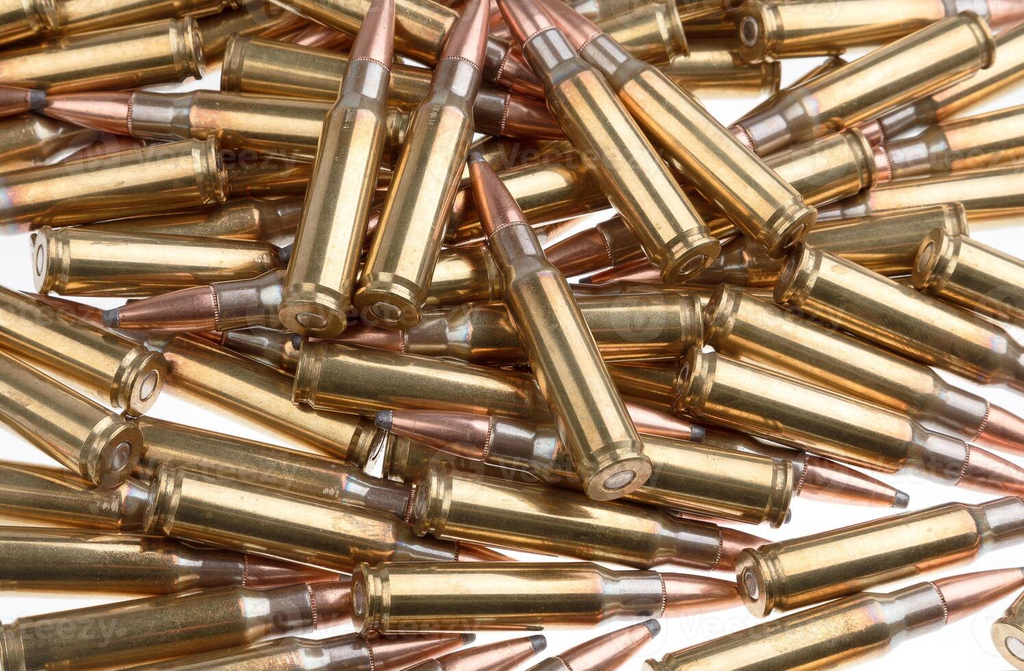 Bullet isolated on white background. Rifle bullets close-up on white back. Cartridges for rifle and carbine. photo