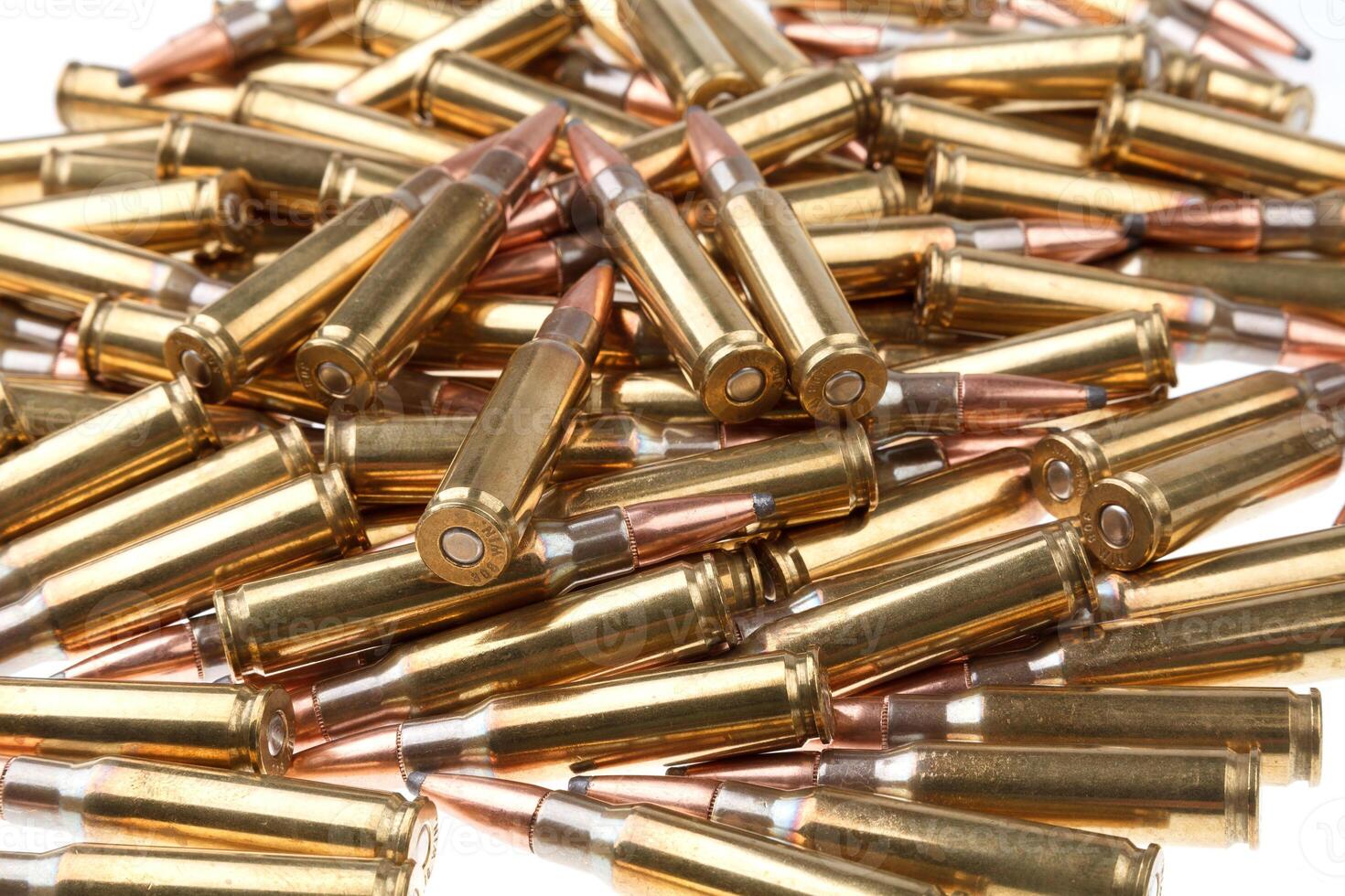 cartridges for 308 caliber rifle on a white background. a bunch of ammo. cartridges scattered on a light background photo