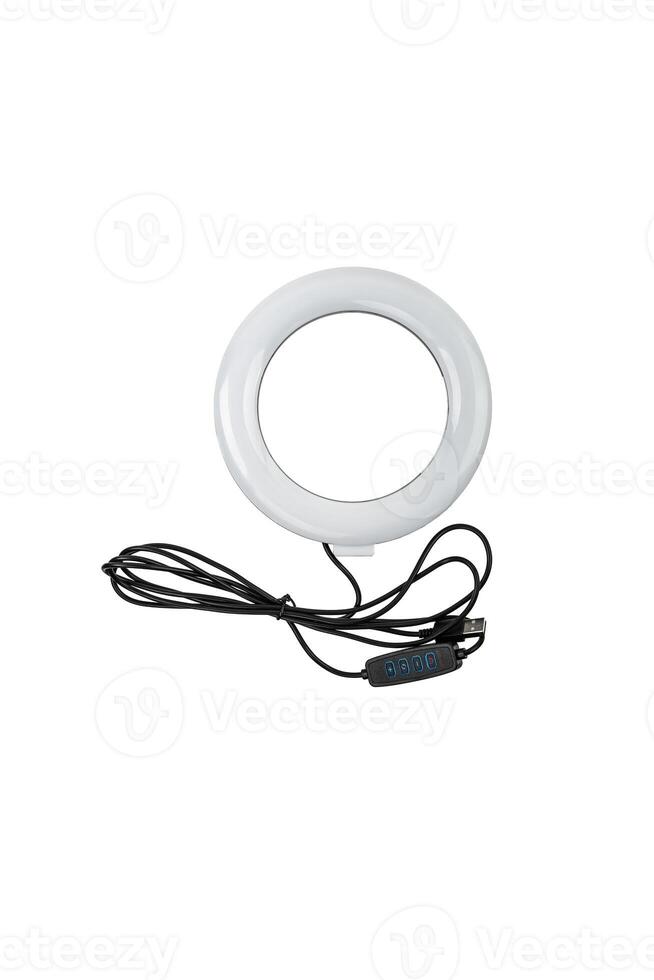 Closeup of circular neon LED lamp isolated white background. Popular modern light for make-up and beauty portraits. photo