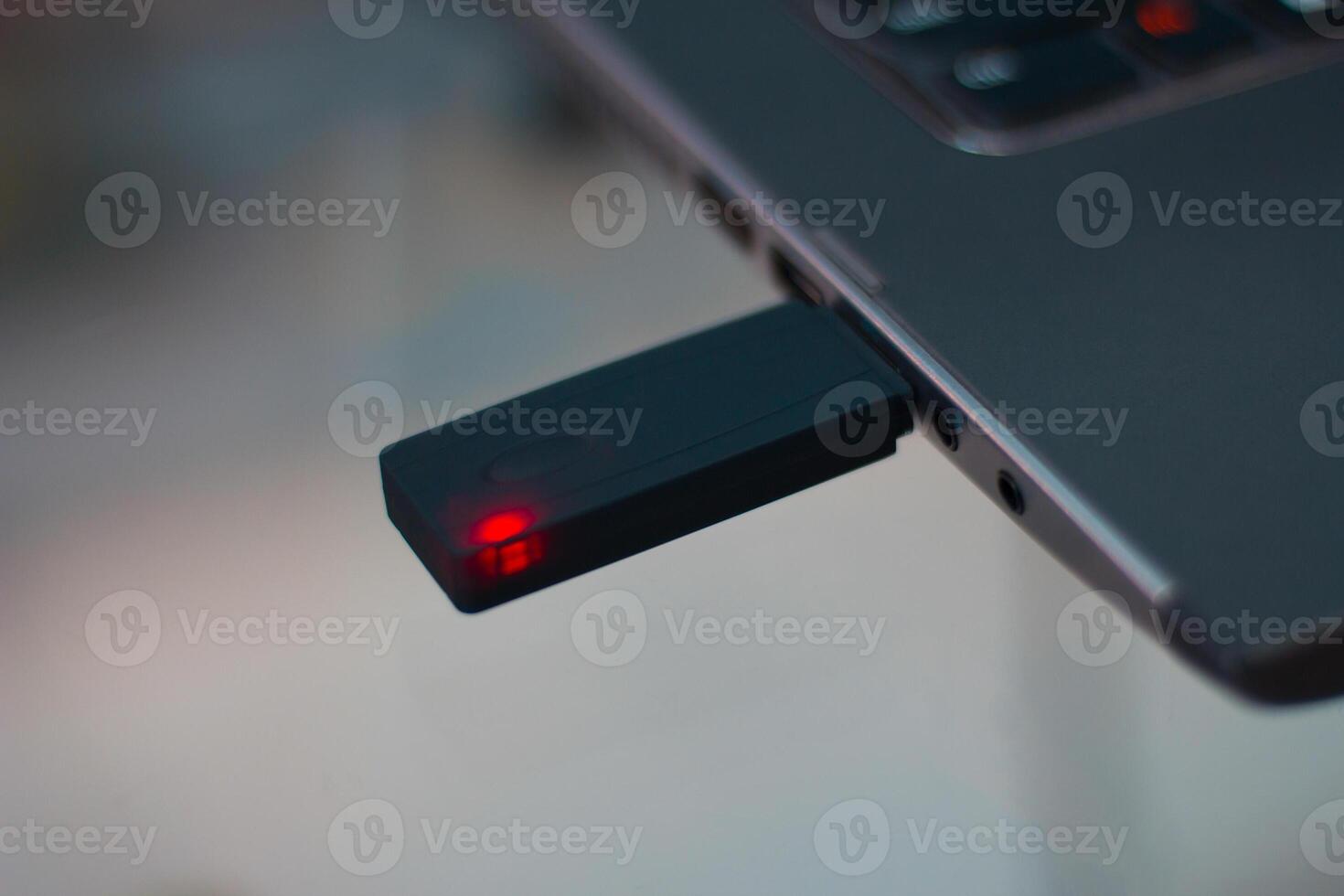 black device with a red light connected to a laptop photo