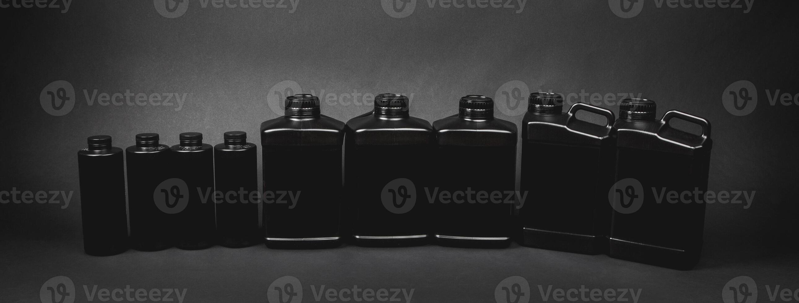 black plastic cans and jars on a black photo