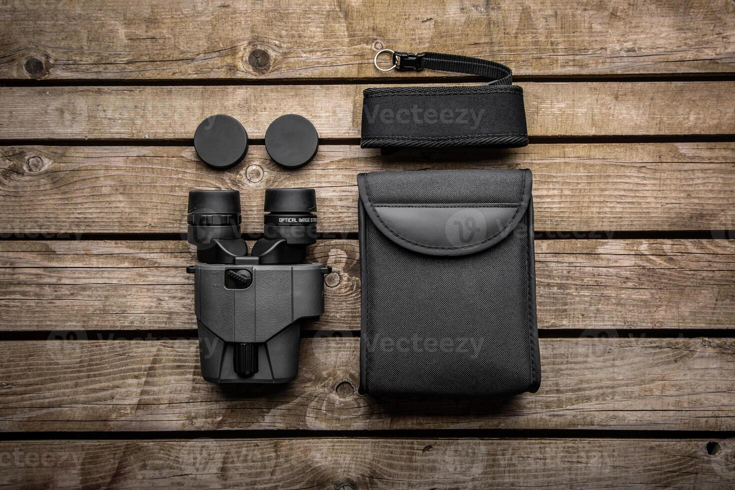 Modern binoculars. An optical instrument for observation at long distances. Wooden back photo