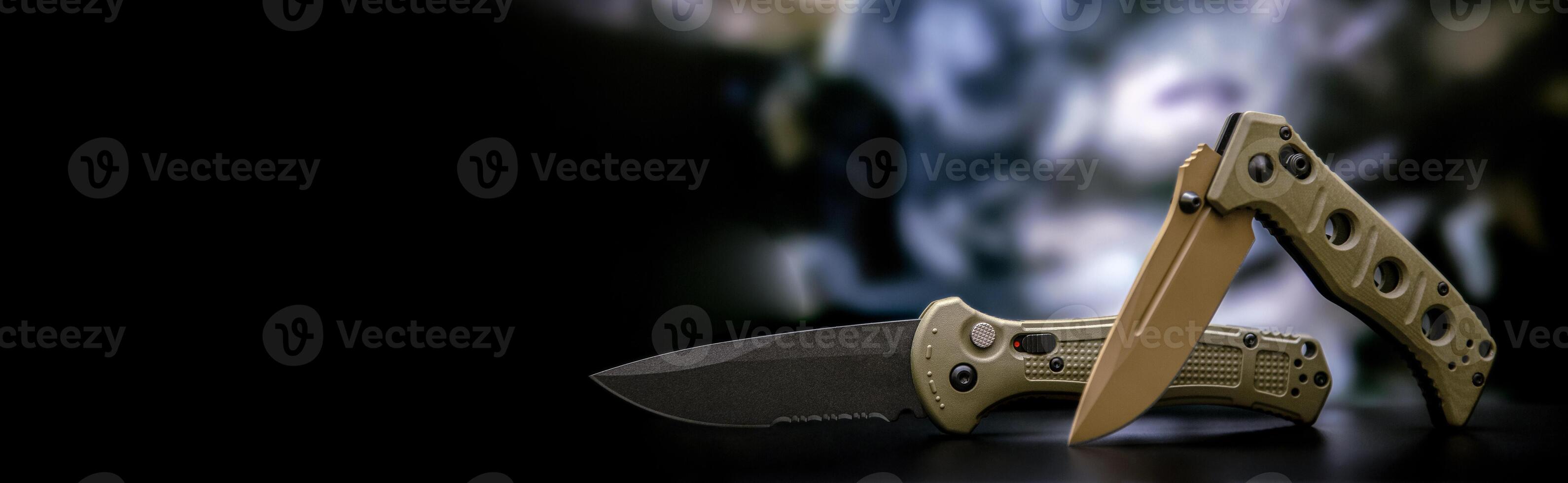 Khaki military pocket folding knives. Compact metal sharp knife with a folding blade. Blurred back. photo