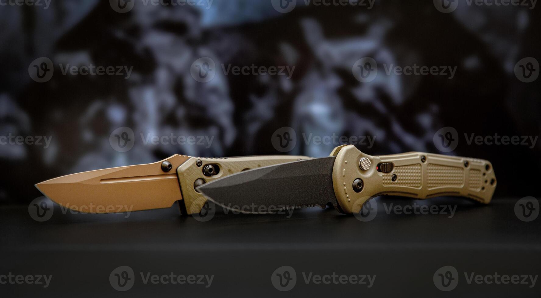 Khaki military pocket folding knives. Compact metal sharp knife with a folding blade. Blurred back. photo
