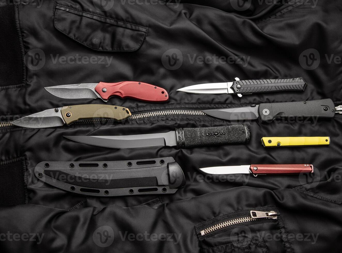 folding knives on a black background. pen knives on a dark background photo