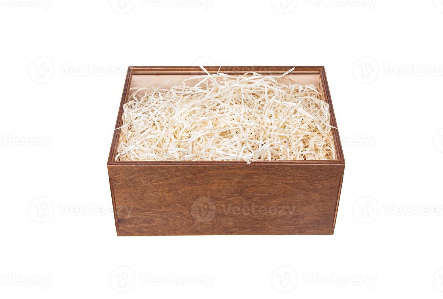Open wooden box with filling material inside. Empty natural wooden box with decorative straw for happy gifts. photo