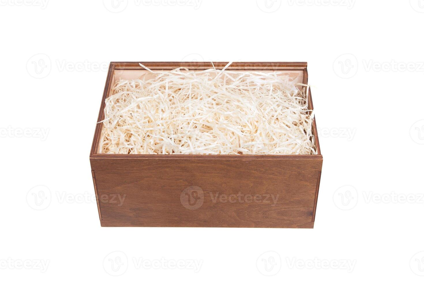 Open wooden box with filling material inside. Empty natural wooden box with decorative straw for happy gifts. photo