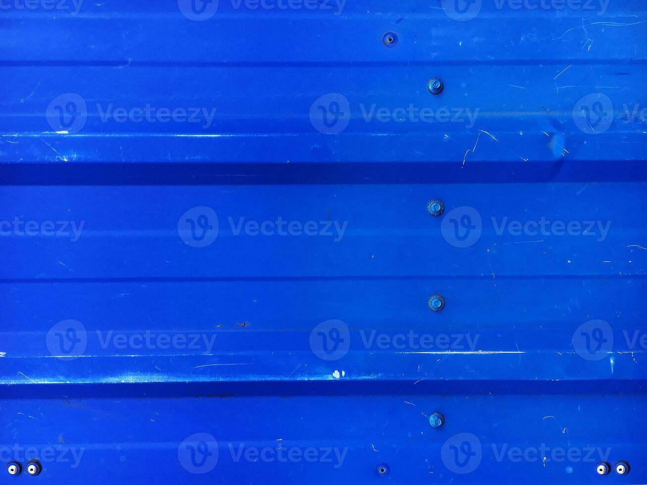 Blue rippled metal texture with bolts photo