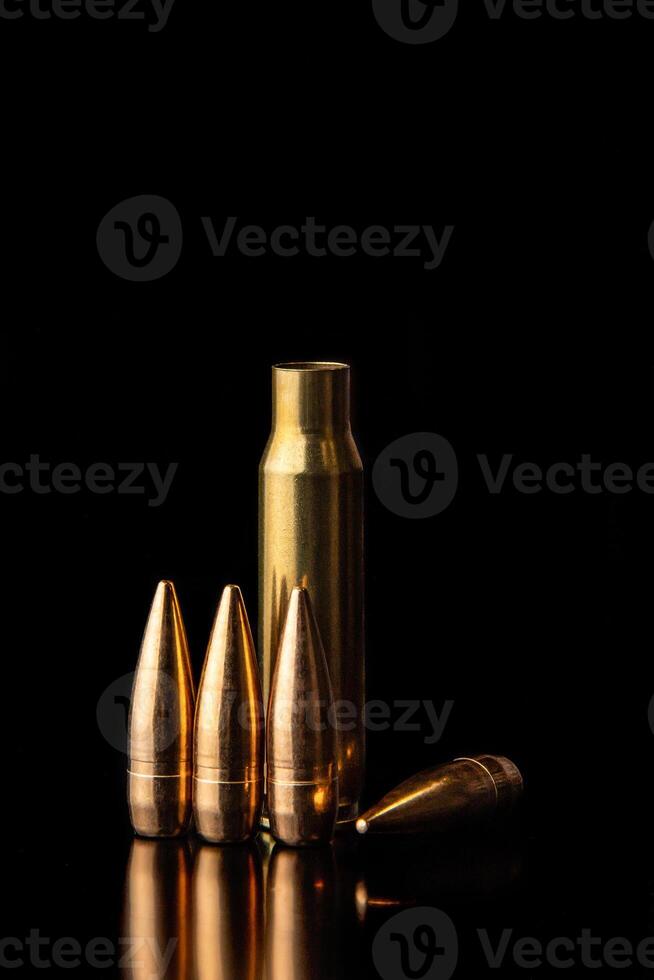 Bullet isolated on black background with reflexion. Rifle bullets close-up on black photo