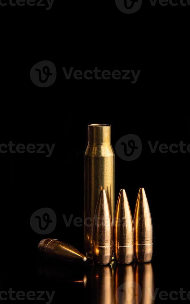 Bullet isolated on black background with reflexion. Rifle bullets close-up on black photo