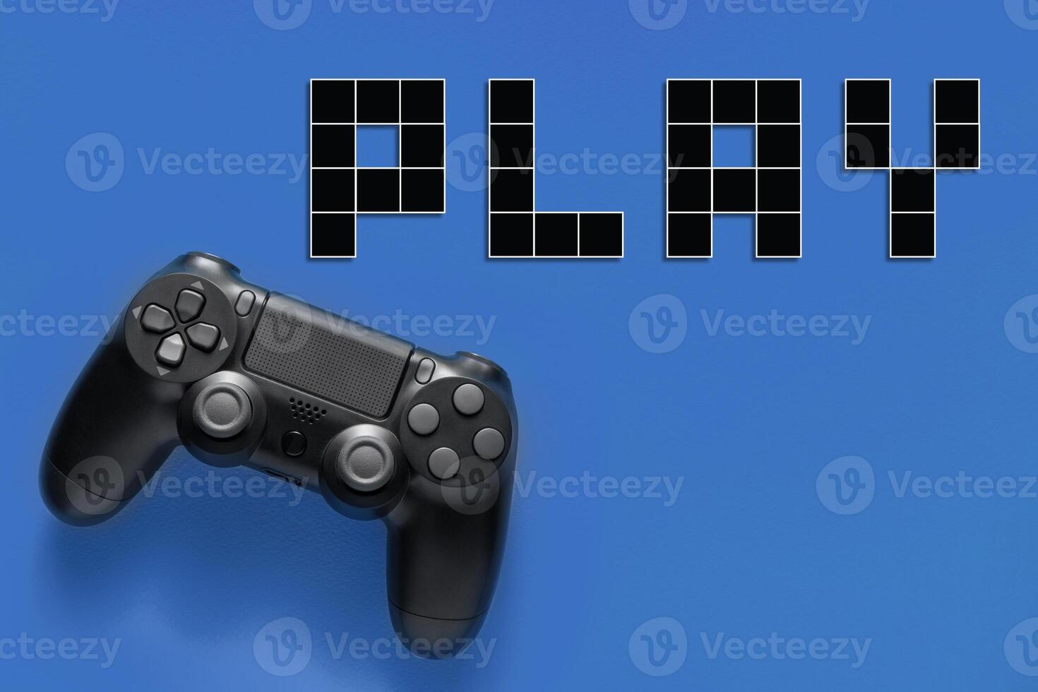 Black modern gamepad and word play on a colored background . Gaming concept photo