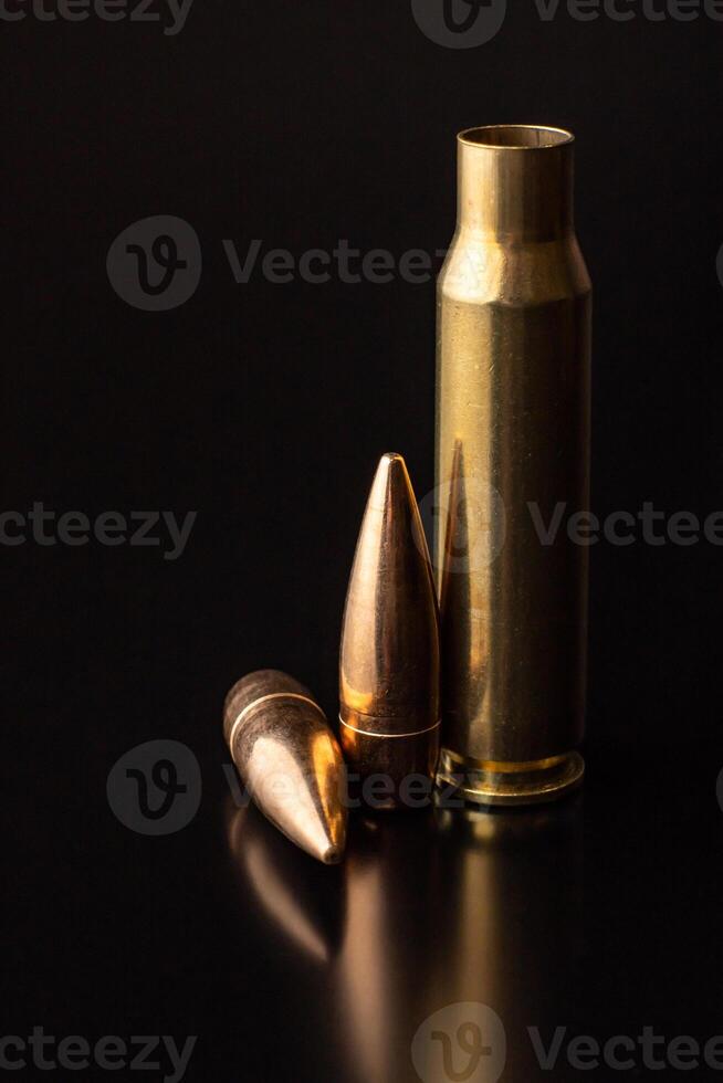 Bullet isolated on black background with reflexion. Rifle bullets close-up on black photo