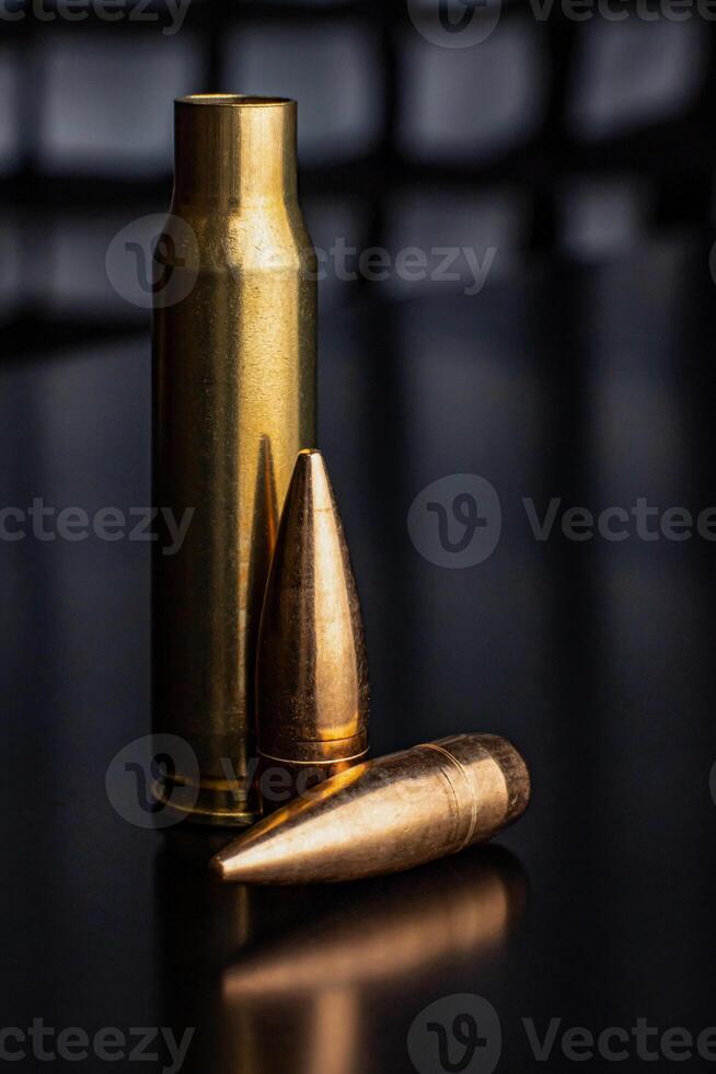 Bullet isolated on black background with reflexion. Rifle bullets close-up on black photo