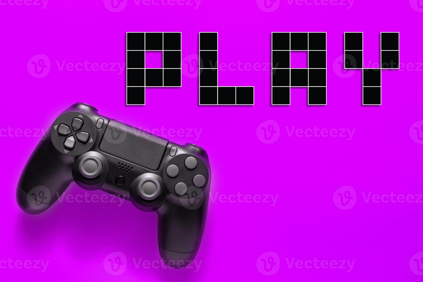 Black modern gamepad and word play on a colored background . Gaming concept photo
