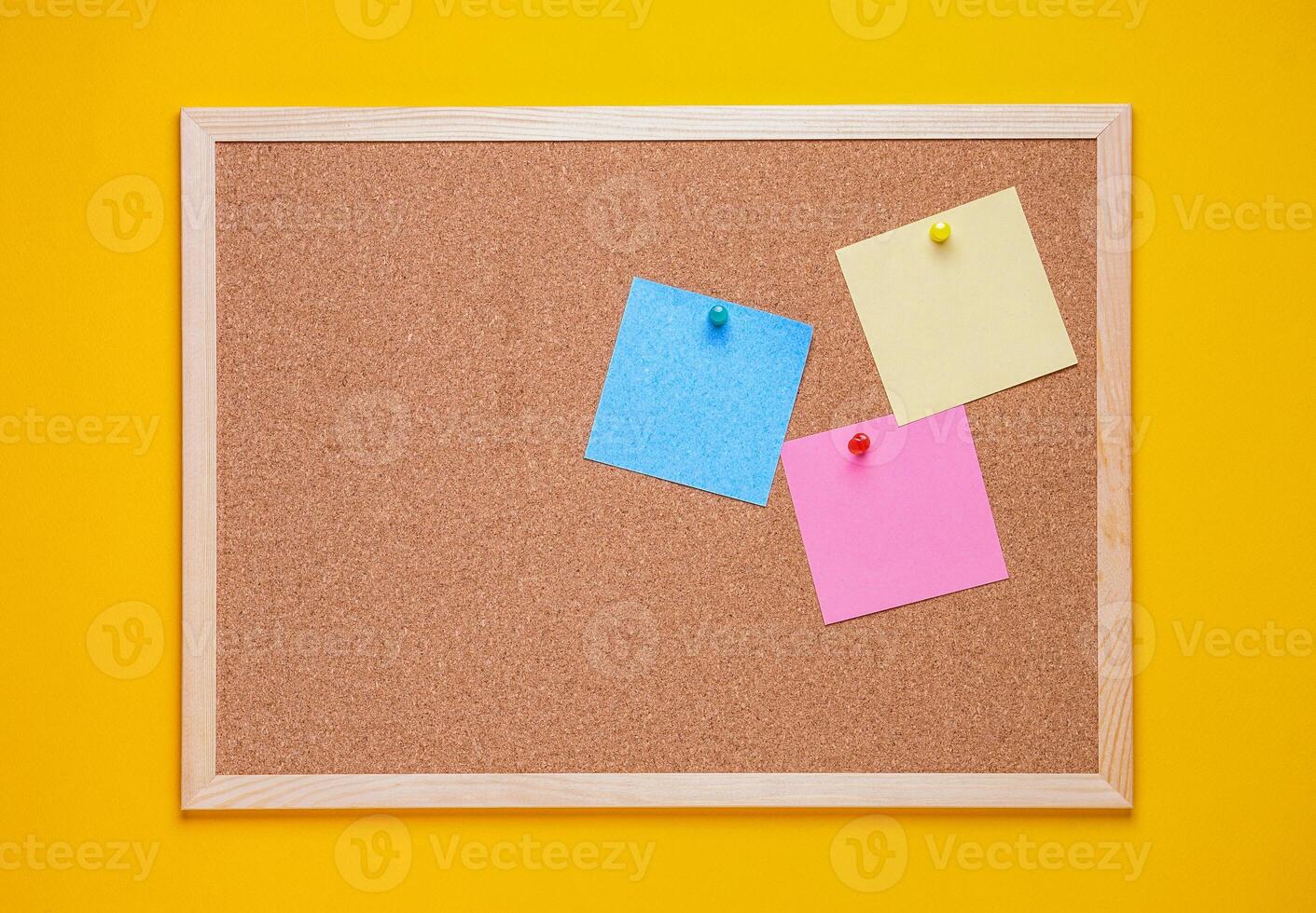 multicolored corkboard stickers pinned with buttons. yellow background. photo