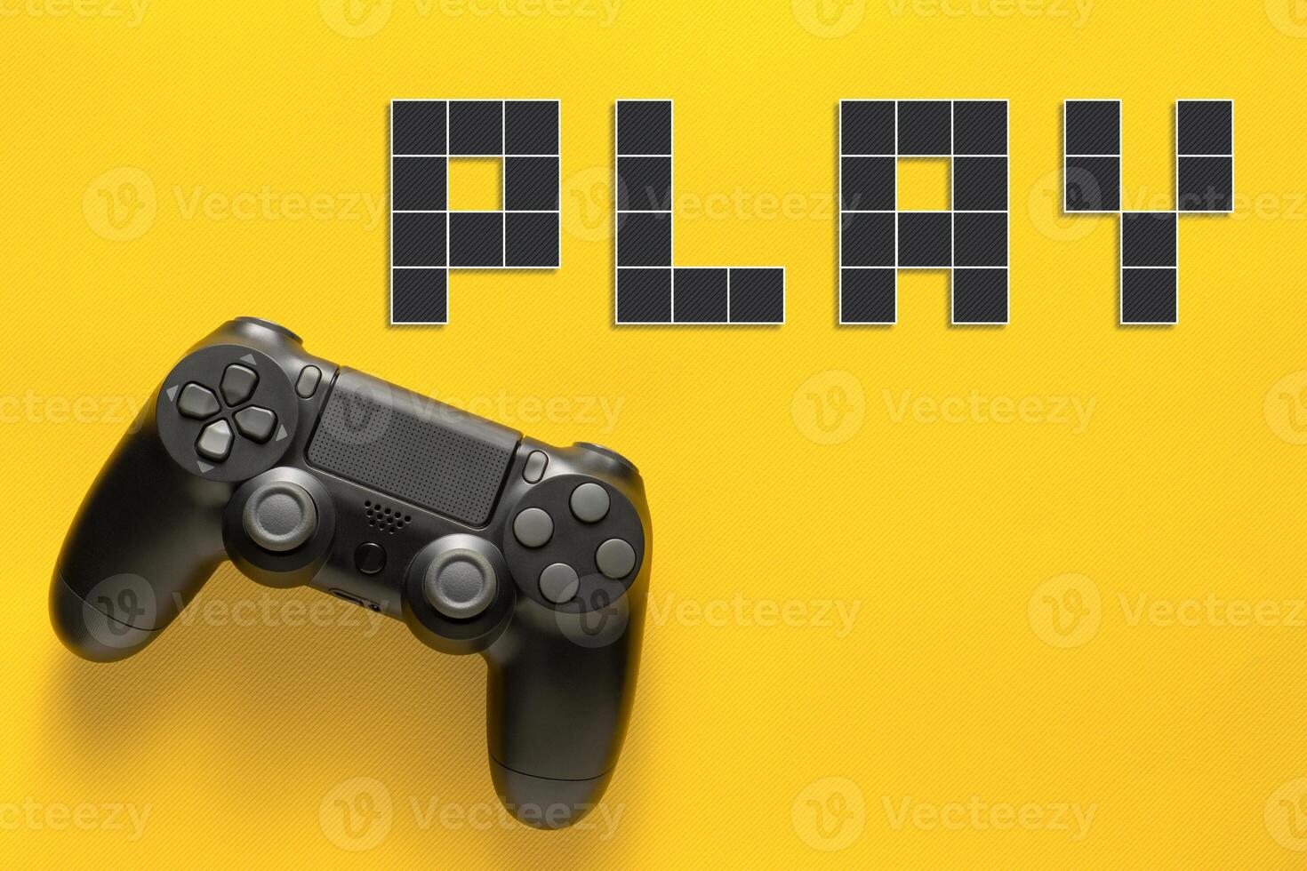 Black modern gamepad and word play on a colored background . Gaming concept photo