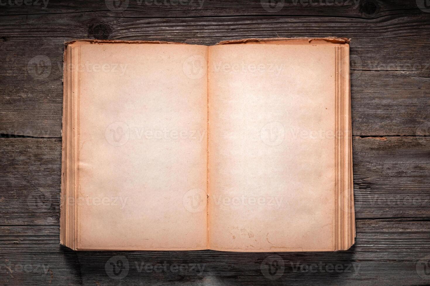 Vintage book, open, on old wooden table, with clipping path. Open Book blank on old wooden background. book with blank pages photo