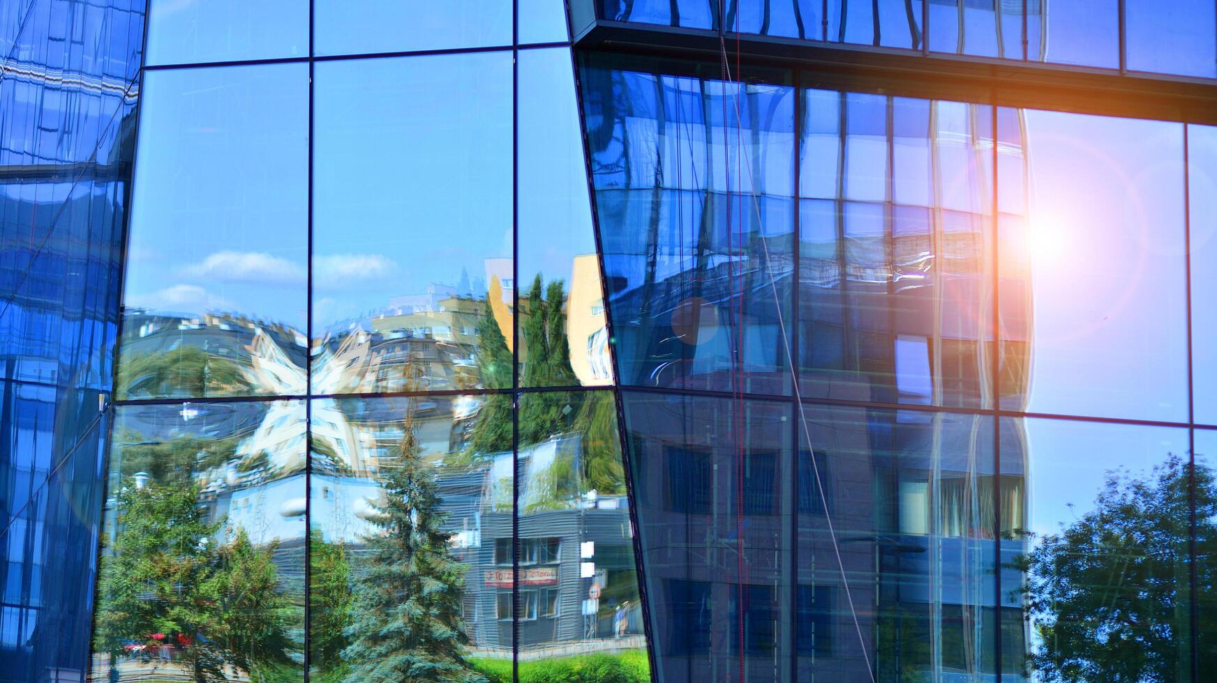 Modern sustainable glass office buildings. Exterior view of corporate headquarters glass buildings architecture.Glass windows in energy-efficient buildings. Financial business center buildings. photo
