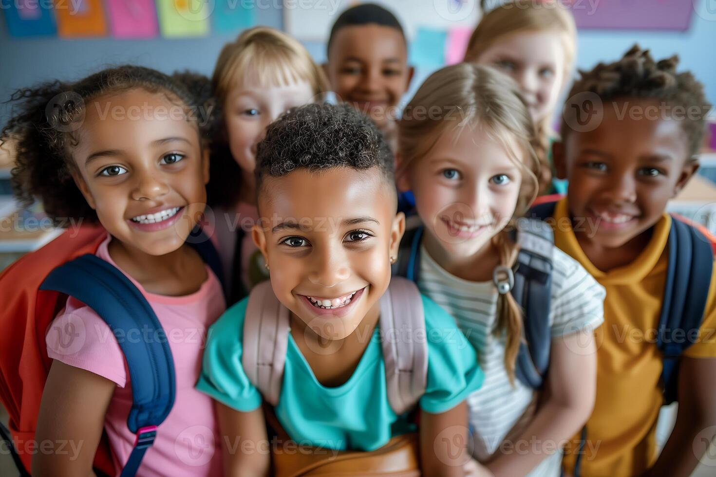 A diverse group of schoolchildren pose for a portrait with bright smiles and backpacks photo