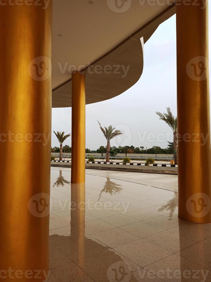 Gold-colored concrete pillars supporting the roof of a mosque in West Java photo