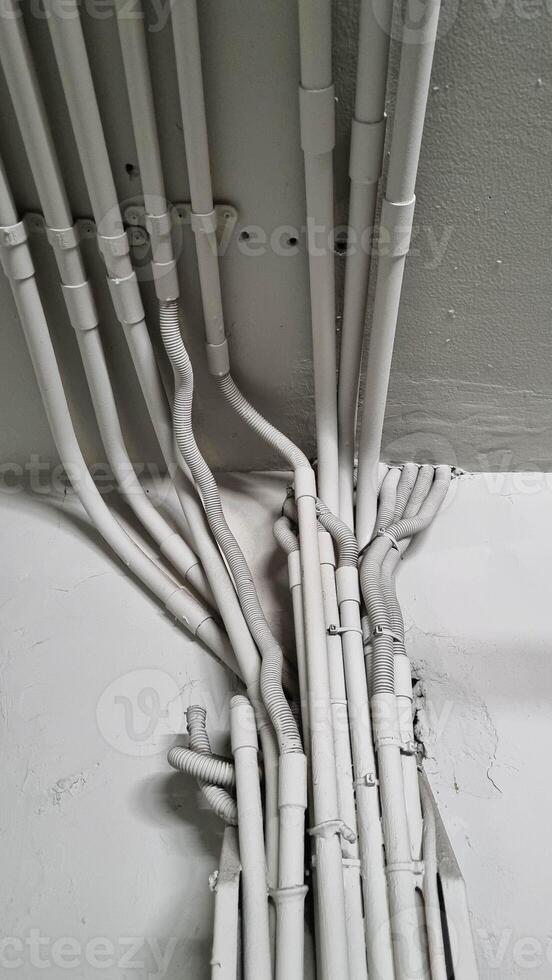 Electrical cable system installation in vertical. Installation of electrical wiring on the ceiling. photo
