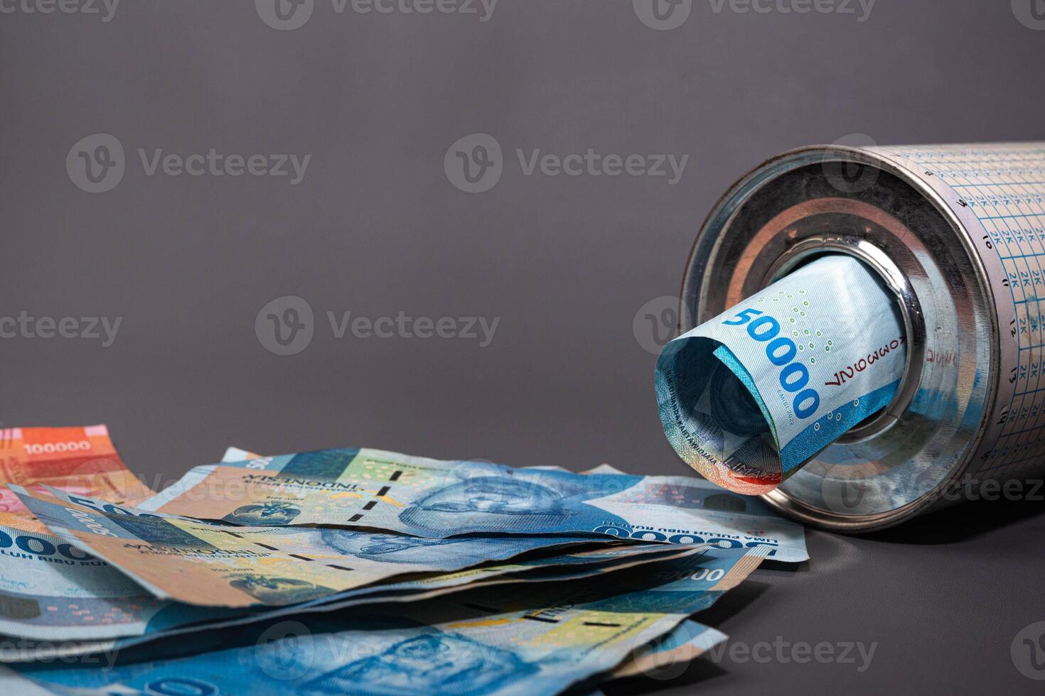 Save Indonesian rupiah in a savings can. Collecting money. Business, finance, savings and banking concept. photo