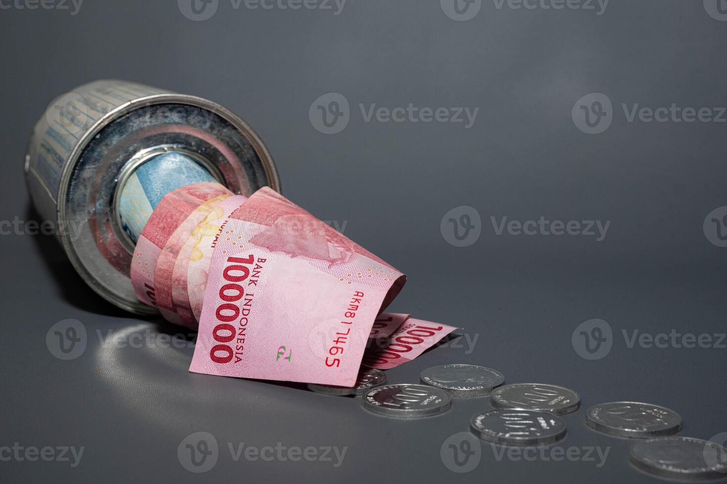Save Indonesian rupiah in a savings can. Collecting money. Business, finance, savings and banking concept. photo