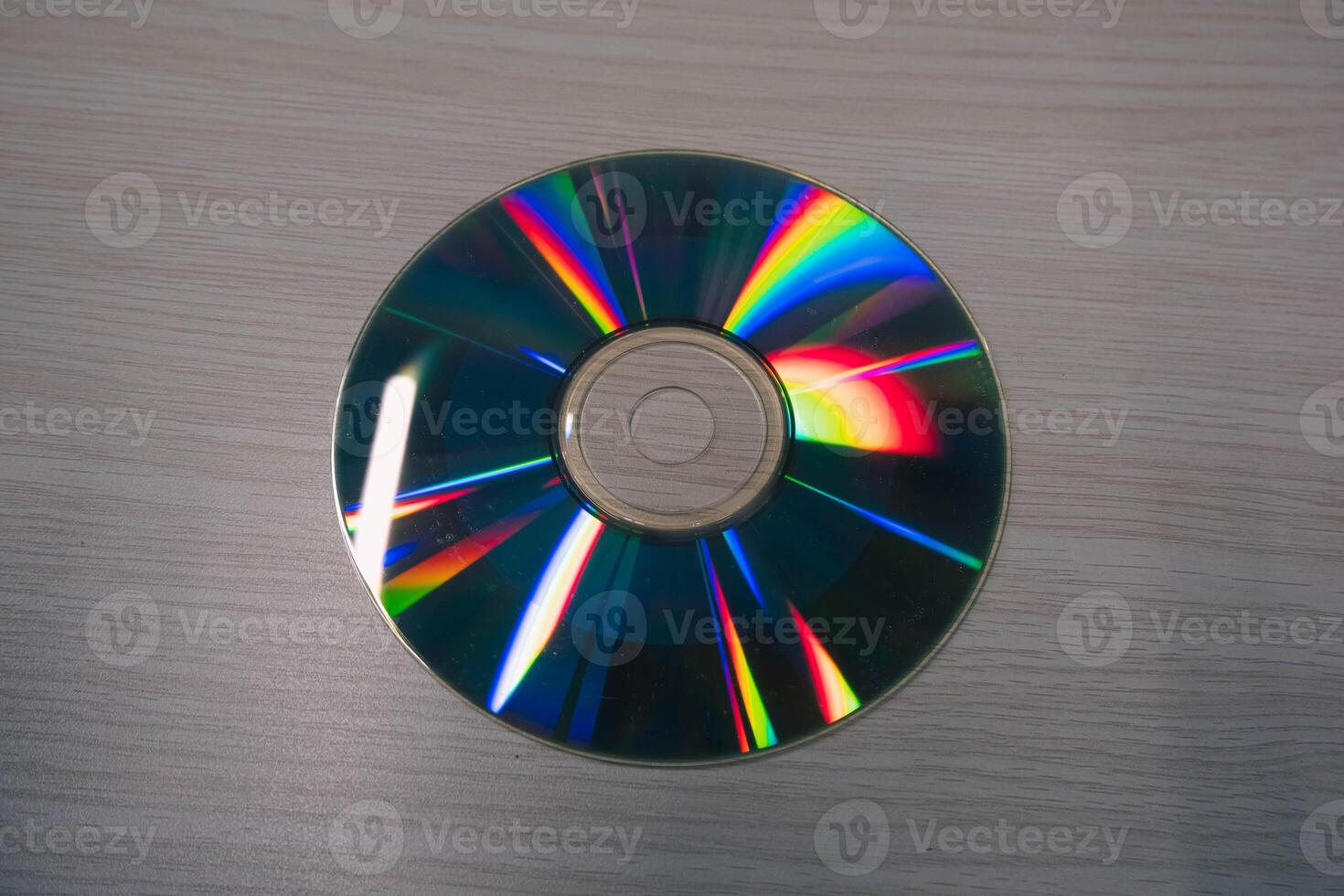 Stack of compact disks on a wooden table. Vcd, blueray photo