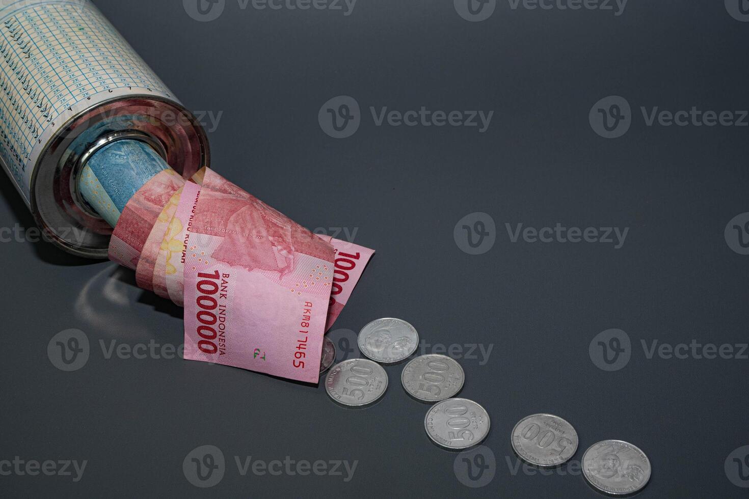 Save Indonesian rupiah in a savings can. Collecting money. Business, finance, savings and banking concept. photo