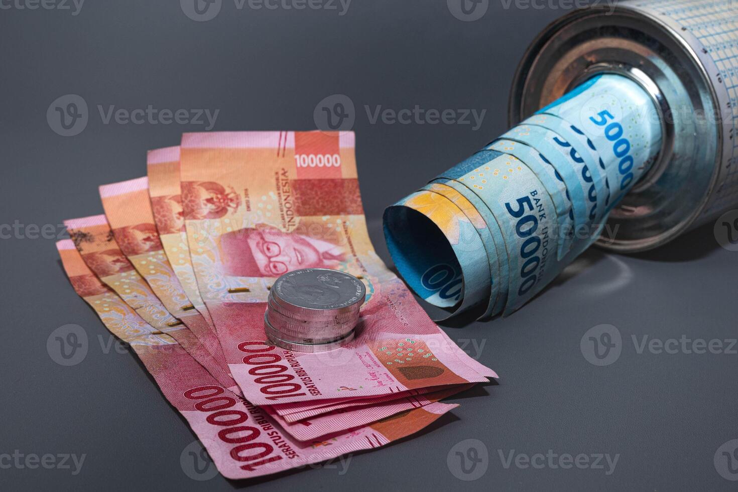 Save Indonesian rupiah in a savings can. Collecting money. Business, finance, savings and banking concept. photo